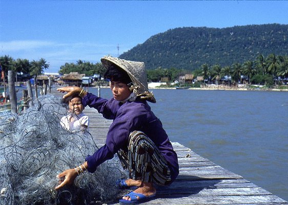 Fisherwoman cleaning net at Ham Ninh Village on Phu Quoc Island Fisherwoman cleaning net at Ham Ninh Village on Phu Quoc Island
