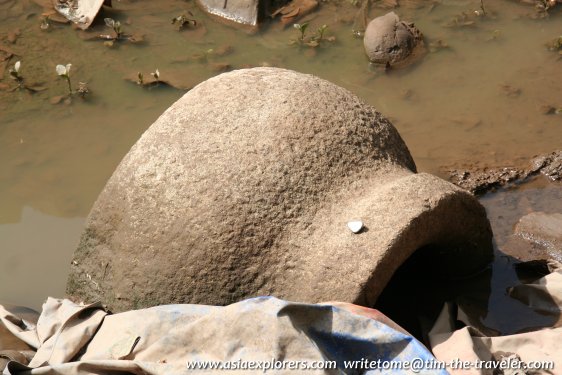 Half buried artifact at Sungai Mas Archaeological Site Half buried artifact at Sungai Mas Archaeological Site